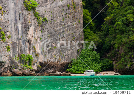 Large granite rock with small beach and boat dock 19409711