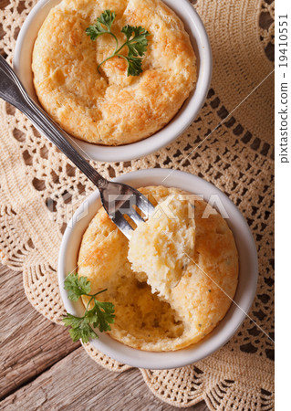 Cheese souffle in a ramekins close-up. vertical Cheese souffle in a ramekins close-up. vertical 19410551