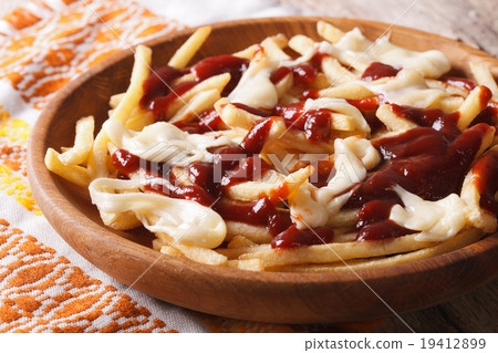 Traditional Canadian fast food poutine with sauce 19412899