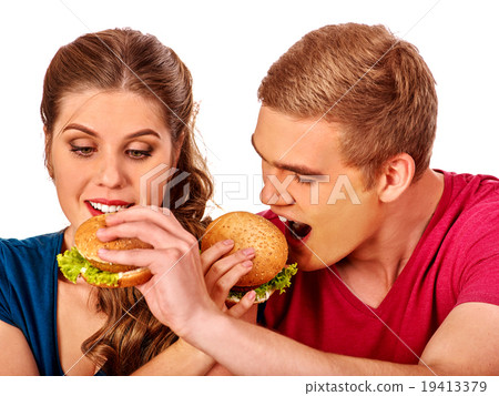 Man and woman eating big sandwich with cola 19413379