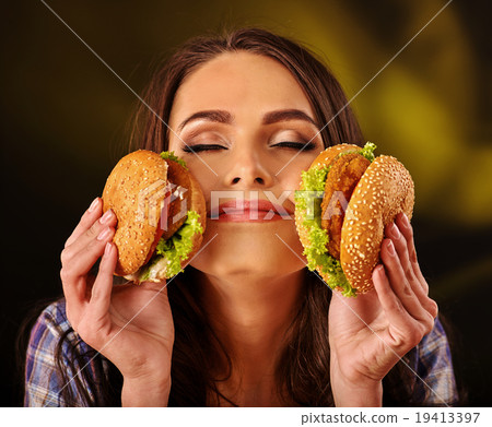 Girl eating big sandwich. 19413397