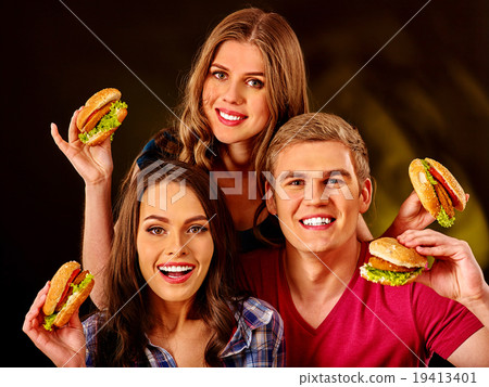 Group people holding big hamburgers . Group people holding big hamburgers . 19413401
