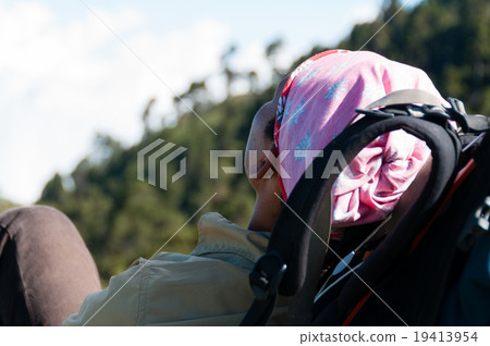 Young Man with pink bandana resting laying on his Young Man with pink bandana resting laying on his 19413954