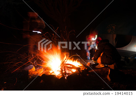 Hikers Gathered Around a campfire at night with Hikers Gathered Around a campfire at night with 19414015