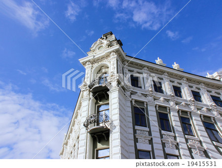 A  balcony of old house overgrown with grapevine. 19415531