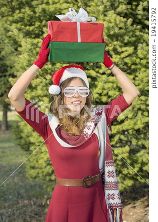 Beautiful Santa Claus girl with Christmas presents 19415792