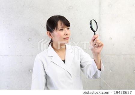 A lady with a magnifying glass 19428657