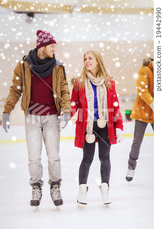 happy couple holding hands on skating rink happy couple holding hands on skating rink 19442990