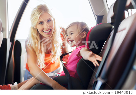 Stock Photo: happy mother fastening child with car seat belt