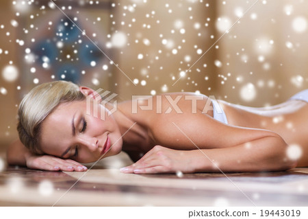 young woman lying on hammam table in turkish bath 19443019
