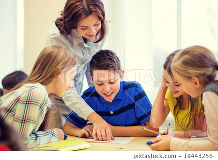 Stock Photo: group of school kids writing test in classroom