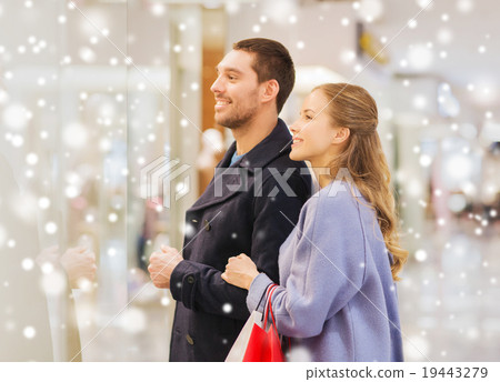 happy young couple with shopping bags in mall happy young couple with shopping bags in mall 19443279