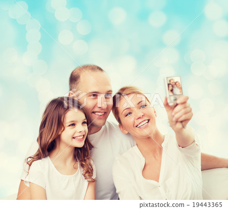 happy family with camera at home 19443365