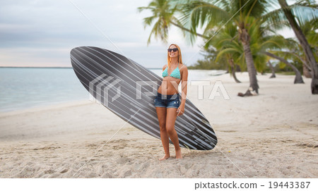 smiling young woman with surfboard on summer beach smiling young woman with surfboard on summer beach 19443387