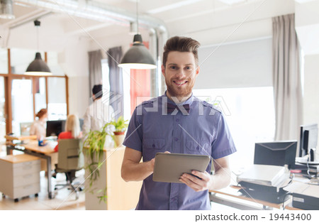 Stock Photo: happy creative male office worker with tablet pc