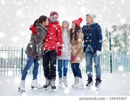 happy friends ice skating on rink outdoors happy friends ice skating on rink outdoors 19443487