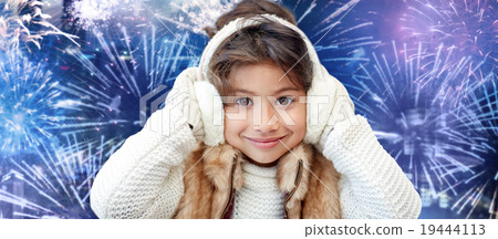 happy little girl wearing earmuffs over firework happy little girl wearing earmuffs over firework 19444113
