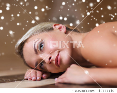 young woman lying on hammam table in turkish bath 19444410