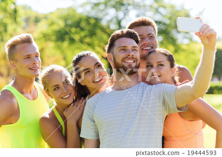 happy friends taking selfie with smartphone happy friends taking selfie with smartphone 19444593