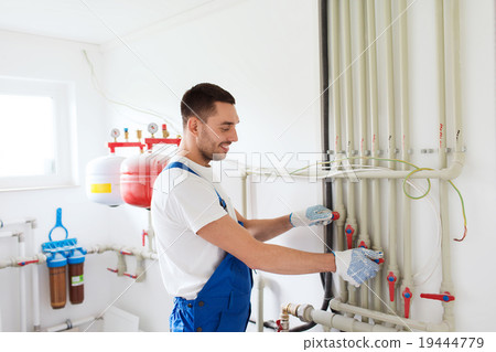 builder or plumber working indoors 19444779