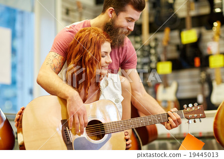 couple of musicians with guitar at music store couple of musicians with guitar at music store 19445013