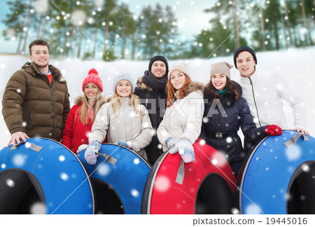 group of smiling friends with snow tubes group of smiling friends with snow tubes 19445016