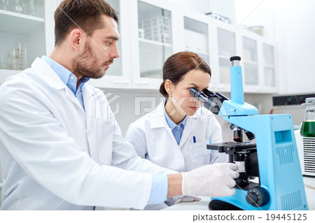 young scientists making test or research in lab young scientists making test or research in lab 19445125