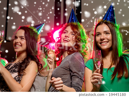 smiling friends with glasses of champagne in club smiling friends with glasses of champagne in club 19445180