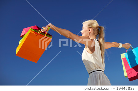 smiling woman with shopping bag rising hands smiling woman with shopping bag rising hands 19445852