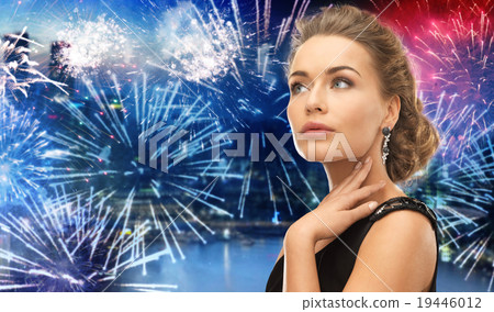 beautiful woman wearing earrings over firework beautiful woman wearing earrings over firework 19446012