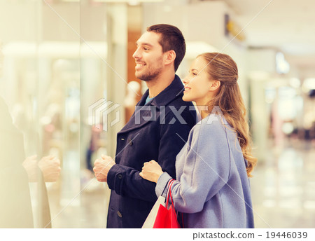 happy young couple with shopping bags in mall happy young couple with shopping bags in mall 19446039