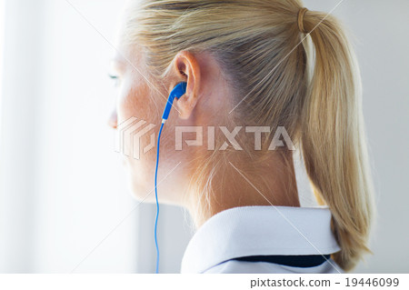 close up of woman in earphones at home close up of woman in earphones at home 19446099