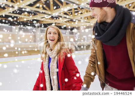 happy couple holding hands on skating rink 19446524