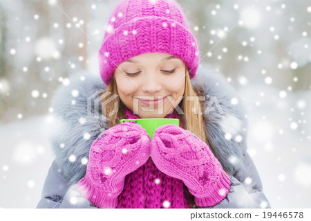 smiling young woman with cup in winter forest smiling young woman with cup in winter forest 19446578