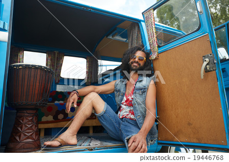 smiling young hippie man in minivan car smiling young hippie man in minivan car 19446768