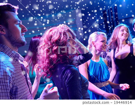 smiling friends dancing in club 19446914