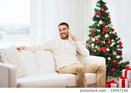man calling on smartphone at home for christmas 19447140