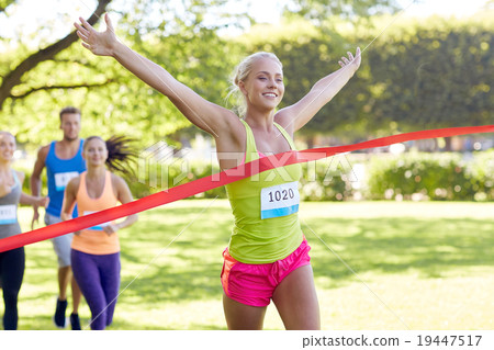 happy young female runner winning on race finish 19447517