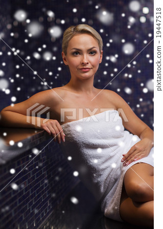 beautiful woman sitting in bath towel at sauna 19447518