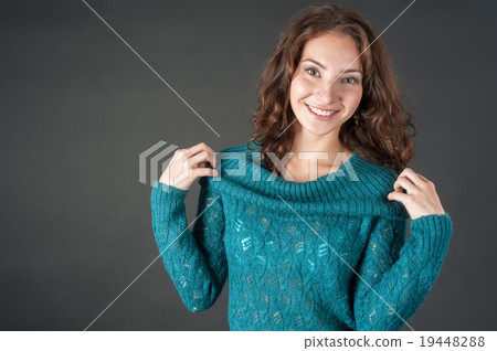 Attractive smiling red-haired womqn in sweater 19448288