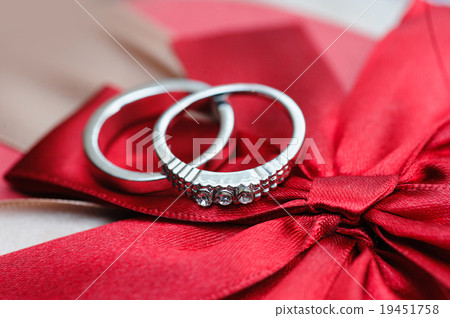 two wedding rings on red background 19451758