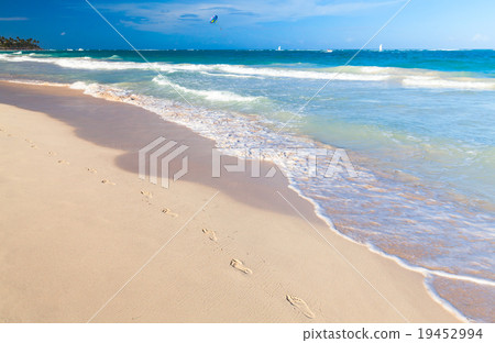 Empty sandy beach with footsteps in sand Empty sandy beach with footsteps in sand 19452994