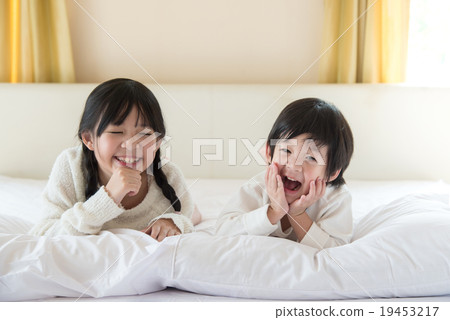 Cute asian children lying on the bed 19453217