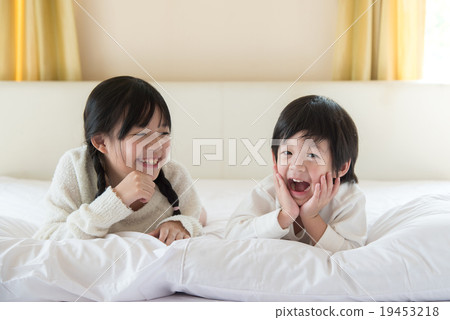 Cute asian children lying on the bed 19453218