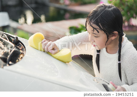 Beautiful asian child washing car Beautiful asian child washing car 19453251