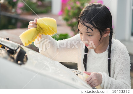 Beautiful asian child washing car Beautiful asian child washing car 19453252