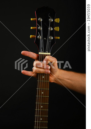 Hand with guitar and devil horns isolated on black Hand with guitar and devil horns isolated on black 19455039