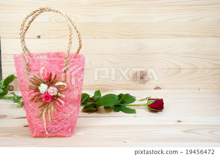 valentine rose with pink bag and wood background 19456472