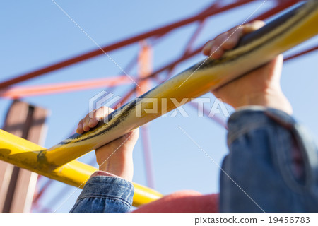 Children hands on playground equipment 19456783