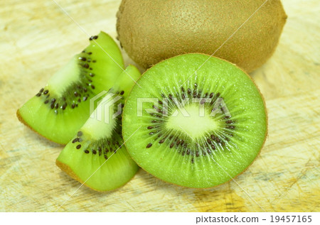 Whole kiwi fruit and his sliced segments isolated Whole kiwi fruit and his sliced segments isolated 19457165